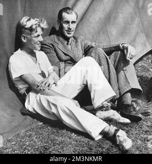 William ('Bill') Tatem Tilden (1893 - 1953), American tennis player, known as 'Big Bill'.  Dominated international tennis in the first half of the 1920s; won Wimbledon three times and the US Open seven times.  Pictured here with his latest protege, Jack Behr, who the editorial describes, was 'adopted by the Master'.  Tilden was a homosexual and served two prison sentences in the 1940s for so-called 'misdemeanours'.       Date: 1931 Stock Photo