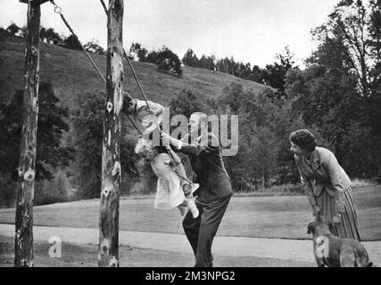 The Queen and Prince Philip play with their children Stock Photo