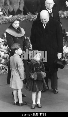 Queen Elizabeth II together with Princess Anne and Prince Charles wait at Waterloo Station with Prime Minister Sir Winston Churchill, for the return of Queen Elizabeth, the Queen Mother who was returning to the UK after her tour of the United States and America in 1954.       Date: 1954 Stock Photo