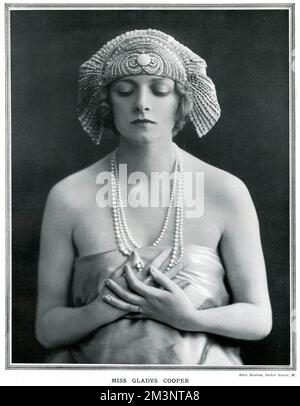 Gladys Cooper (1888 - 1971), British actress of stage and screen, looking very serene in an exotic headdress and strings of pearls.     Date: 1923 Stock Photo