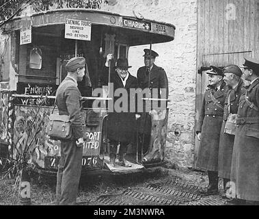 Sir Kingsley Wood (1881 - 1943), Secretary of State for Air pictured during a tour of the R.A.F. in France, the first British Defence Minister to visit British Forces overseas in 1939.  He is seen before a bus which has been converted for office use and is adorned with humorous slogans and signs.  Behind him is Air Vice-Marshal Peirse; on the right are Air Vice-Marshal P.H.L. Playfair, Air Officer Commanding the RAF in France and wo staff officers - Group-Captain A. H. Wann and Air-Commodore J. C. Quinnell.       Date: 1939 Stock Photo