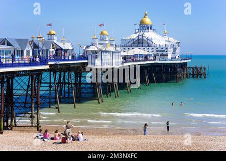 Eastbourne East Sussex Eastbourne beach and Eastbourne pier with people on the beach Eastbourne beach Eastbourne East Sussex England UK GB Europe Stock Photo