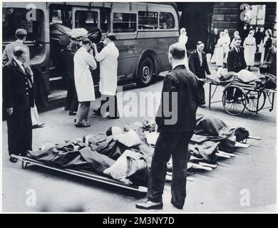 Evacuating hospital patients from a London hospital at the beginning of World War Two. For the evacuation of patients to the country, motor coaches were temporarily converted into motor ambulances. Stock Photo