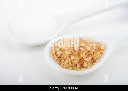 White and brown sugar in spoon isolated on white background Stock Photo