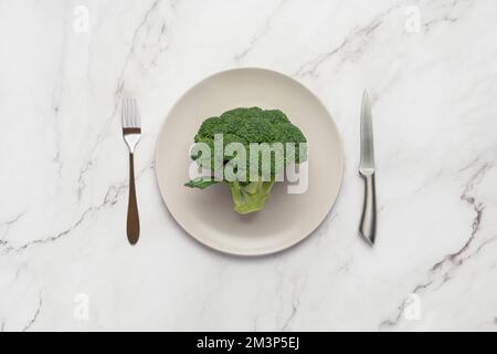 Broccoli in a gray plate on a gray background Stock Photo