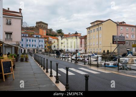 Muggia, Italy (8th December 2022) - The area of the port with view on the historical center and the above castle Stock Photo