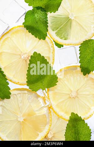 Texture with lemons, mint, ice cubes on white isolated background Stock Photo