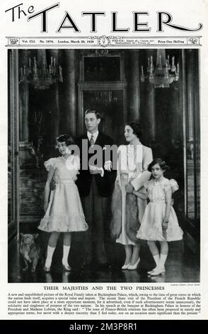 George VI and Queen Elizabeth consort also known as Queen Mother, with their two daughters Princess Elizabeth (future Queen Elizabeth II) left and Princess Margaret, right, taken at Buckingham Palace.  March 1939 Stock Photo