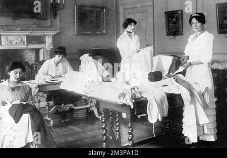 Viscountess Gladstone, along with the Hon. Lilian and Winifred Douglas Pennant (half -sisters of Lord Penrhyn) and Miss Poole working to provide garments and hospital dressings for the four London Territorial Base Hospitals being set up in the capital during the first few weeks of the First World War.       Date: 1914 Stock Photo