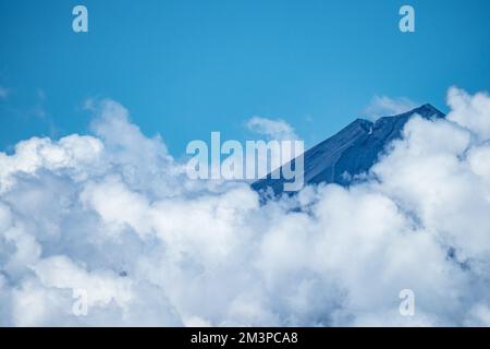 Clouds forming above volcano in the south Pacific Ocean - Ring of fire Volcano in Papua Stock Photo