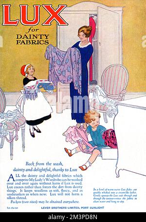 Advertisement for Lux soap, manufactured by Lever Brothers at Port Sunlight.  Ideal for 'dainty fabrics' the illustration shows a mother and her children sorting through clothing from her drawers and wardrobe in her bedroom.       Date: 1923 Stock Photo