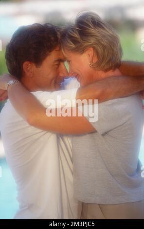 White middle-aged couple embracing with foreheads touching Stock Photo