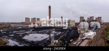 DRAX POWER STATION, UK - NOVEMBER 27, 2022.  Aerial panorama view of a large coal fired power plant with low stocks of coal and storage tanks for Biof Stock Photo