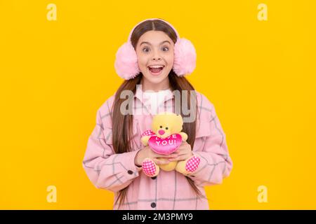 What a happy surprise. Surprised child hold teddy. Toy gift for Valentines day. Valentines present Stock Photo