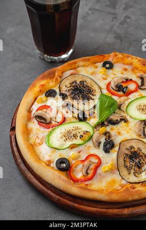Vegetarian pizza with eggplant, zucchini and mushrooms on dark stone table Stock Photo