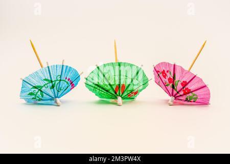 three open parasols ready to place in cocktails Stock Photo