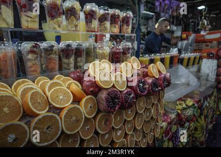 Tel Aviv, Israel. 16th December, 2022. A shopkeeper prepares fruit drinks at the Shuk HaCarmel Market, an outdoor marketplace established in the 1920s Stock Photo