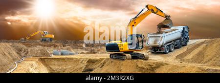 excavator ist working and digging at construction site Stock Photo