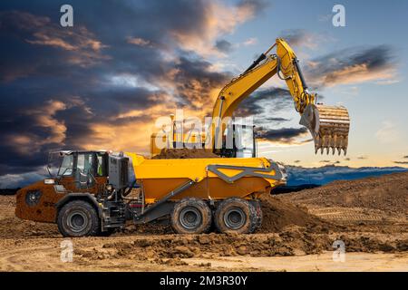 excavator ist working and digging at construction site Stock Photo
