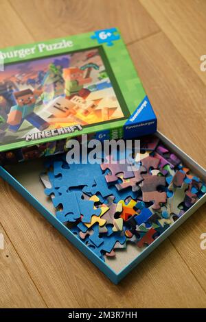A closeup of Ravensburger brand Minecraft puzzle in a box on the wooden  surface Stock Photo - Alamy