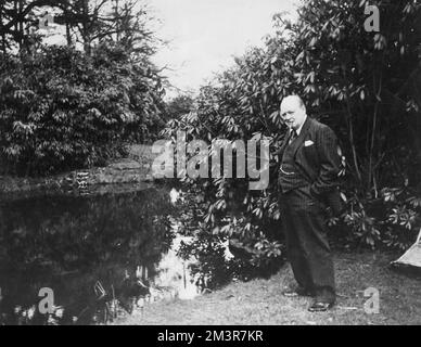 Winston Churchill by one of the lakes at his home, Chartwell Manor, Westerham, Kent in 1939. &quot;Admiralty Billet for fish? First Lord of the Admiralty Mr Winston Churchill has offered to let Mr Stanley Plater, one of the biggest pet fish breeders in the country transport fish from the his North London home to Chartwell, Westerham, Kent, where Mr Churchill keeps thousands of live fish in lakes at his home, should it become necessary. Breeding fish is one of Mr Churchill's hobbies.&quot;     Date: 1939 Stock Photo