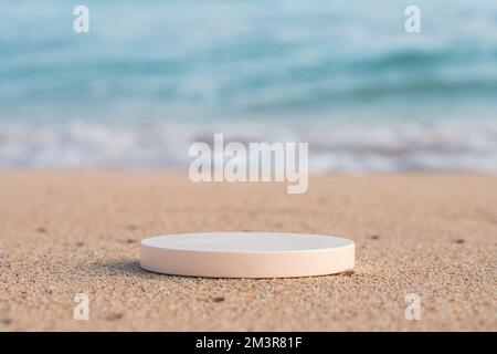 Empty round white platform podium on the beach Stock Photo