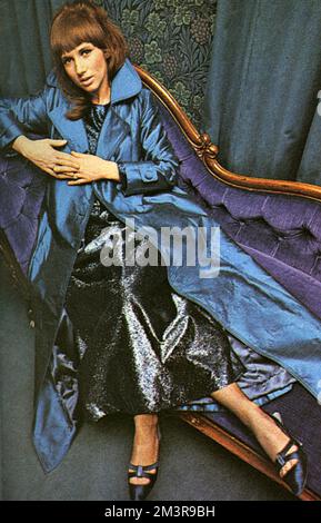Wendy Cook, n&#x9960;Snowden, first wife of the comedian Peter Cook.  The couple married in 1963 and divorced in 1970. In this photo, she is wearing a kingfisher blue wild silk long evening coat over a full-length evening dress in blue and purple pure silk lam&#x9834;hat she designed.     Date: 1966 Stock Photo