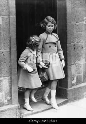 Princess Elizabeth (future Queen Elizabeth II) and Princess Margaret leaving a Forfar bookshop during a shopping outing with their mother in August 1935.     Date: 1935