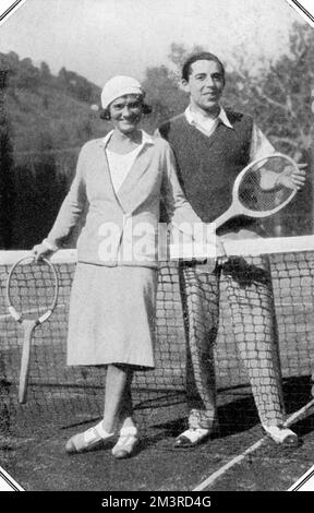 Gabrielle (Coco) Chanel, French fashion designer, pictured with the splendidly named Baron Pantz, taking a moment from their tennis match on the French Riviera.  Chanel owned what The Tatler describe as, 'one of the most beautiful villas on the Riviera,' - Roquebrine.     Date: 1931 Stock Photo