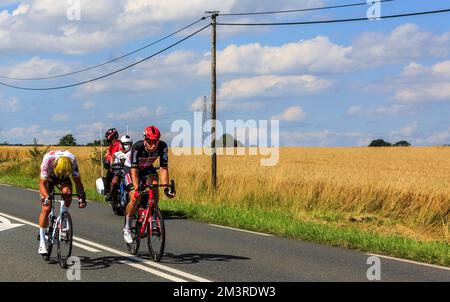 Les Vignes du Chateau, France - July 1,2021: Image of the breakaway riding on a road in the field during the Tour de France 2021. Stock Photo