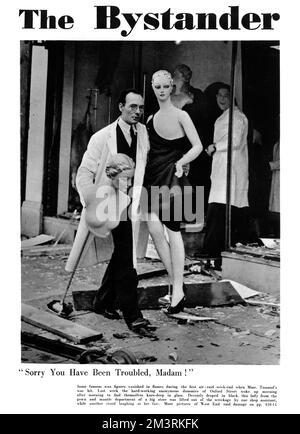 The front cover of The Bystander features a shop assistant rescuing two mannequins after an Oxford Street department store is hit by a Luftwaffe bombing raid. In the background a second shop assistant appears amused at the plight of the two dummies.  1940 Stock Photo