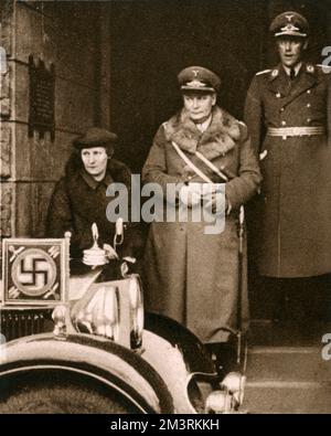 General Hermann Goering pictured leaving St. George's Church, the British church in Berlin, where he had attended a service of mourning for the late King George V.  Accompanying him is his wife, Emmy.     Date: 1936 Stock Photo