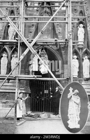 Statues of patron saints, donated anonymously in thanksgiving for the end of the Great War, are hoisted into position in the empty niches round and above the north porch of Exeter Cathedral.  The seven statues represented the patron saints of the Allies and were the work of Herbert Read, an Exeter sculptor.  The statue of St. George trampling the dragon underfoot is shown in the insert picture.     Date: 1920 Stock Photo