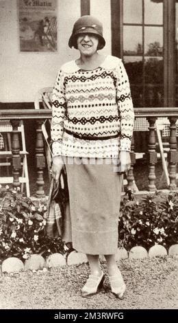 Suzanne Lenglen (1899-1938) who had just won the The Ladies Tennis Championship at Wimbledon for the fifth time in succession that year, pictured at ease at Biarritz in 'her latest jumper'.  1923 Stock Photo