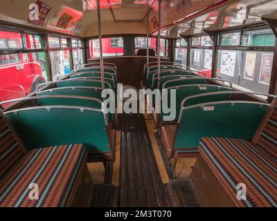 Seating area downstairs inside a 1952 AEC Regent III  London Transport green bus, London Bus Museum, part of Brooklands Museum, Surrey, UK. Stock Photo