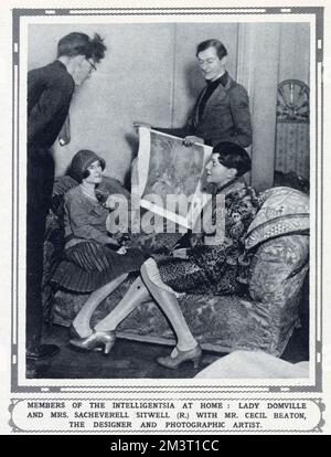 The designer and 'photographic artist' Cecil Beaton (standing - r) showing costume designs to Lady Domville (seated, left) and Mrs Sacheverell Sitwell (seated, right) intended for The Dream of the Fair Women Ball (The Pageant of Past, Present and Future Fashions) – held on 29th February 1928 at Claridges, London in aid of the Winter Distress League.