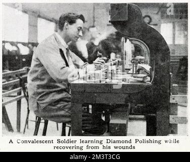 Learning diamond-polishing while recovering from wounds, a convalescent soldier at work. A pilot scheme was started in spring 1917 by Mr. Bernard Oppenheimer, a diamond merchant. The factory provided training for thousands of wounded ex-soldiers and sailors during and after World War One. Stock Photo