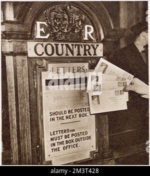 Some of the first letters to bear the stamps of the new reign of Queen Elizabeth II being posted at the General Post Office in London, just after midnight on December 5 1952, in special envelopes. Stock Photo