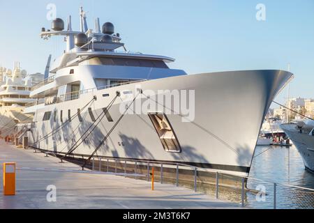 Luxury yacht moored in the seaport. Marine parking of modern motor boats. Close-up Stock Photo