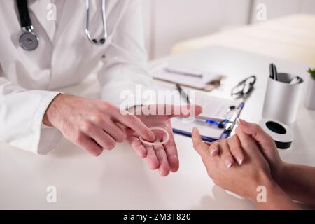 Gynecologist Showing Contraception Ring To Woman And Explaining Birth Control Stock Photo