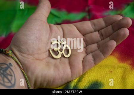 OM sign from Hindu and Buddhist religion on palm, symbol for good luck Stock Photo