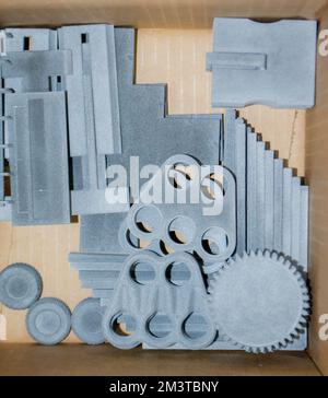 Gray models printed on 3D printer from polyamide powder in box close-up. Top view. Objects printed on 3D printer from plastic. 3D printed prototype. New modern printing technology. Multi Jet Fusion Stock Photo