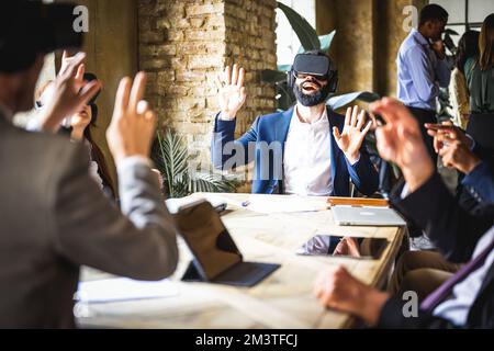 business people using augmented reality headset for a virtual meeting, bearded businessman amazed while scrolling documents in virtual space and searc Stock Photo