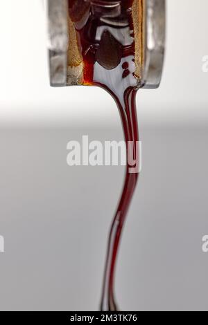 pouring fresh espresso coffee from coffee machine, macro, selective focus Stock Photo