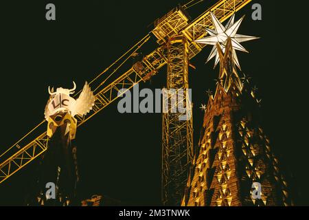 Barcelona, Spain. 16th Dec, 2022. The pinnacles of the towers of the Evangelist Luke of the Basilica 'La Sagrada Familia' is illuminated for the first time marking the completion of the tower. The towers is topped with a winged figure corresponding with Christian iconography: an ox for Luke. Together with the tower of the Virgin Mary, inaugurated one year ago, three of the six central towers are now completed. Credit: Matthias Oesterle/Alamy Live News Stock Photo