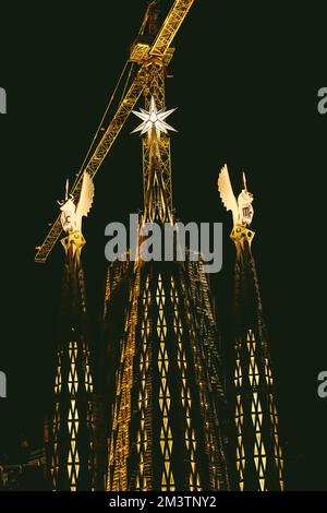 Barcelona, Spain. 16th Dec, 2022. The pinnacles of the towers of the Evangelists Luke and Mark of the Basilica 'La Sagrada Familia' are illuminated for the first time marking the completion of the towers. Both towers are topped with winged figures corresponding with Christian iconography: an ox for Luke and a lion for Mark Together with the tower of the Virgin Mary, inaugurated one year ago, three of the six central towers are now completed. Credit: Matthias Oesterle/Alamy Live News Stock Photo