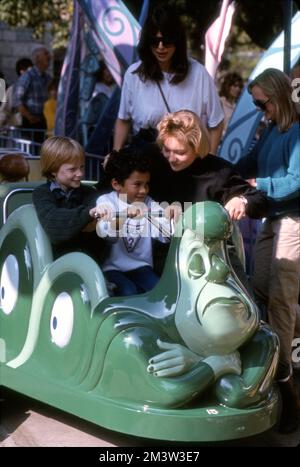 Visitors to Disneyland in a car for the Alice in Wonderland ride, Anaheim, CA Stock Photo