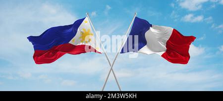 crossed national flags of France and Philippines flag waving in the ...