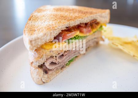 Toasted Texas Club Sandwitch ready to eat with crisps Stock Photo