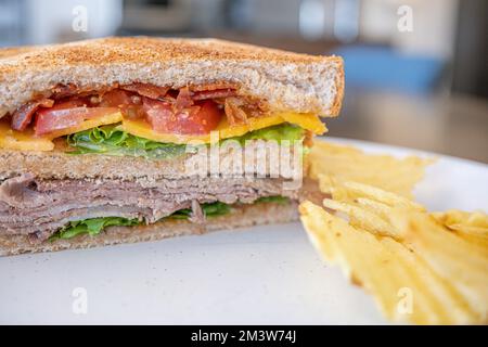 Toasted Texas Club Sandwitch ready to eat with crisps Stock Photo